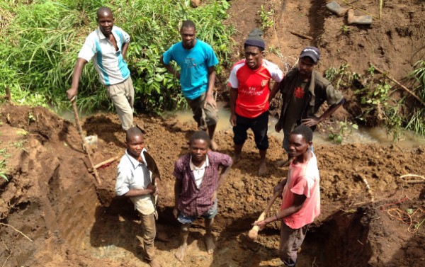 Excavation for the bridge foundations start with help from Elijah and 2 of our gardeners 